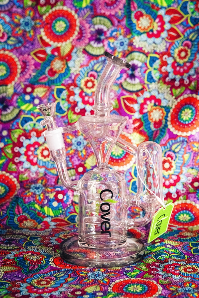 A picture of a Clover Water Pipe with a groovy pink 70s esqu background