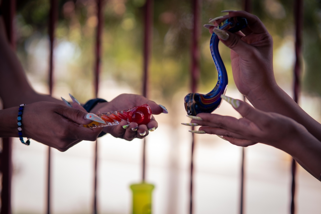 A set of two glass pipes side by side being heldup by a persons hands